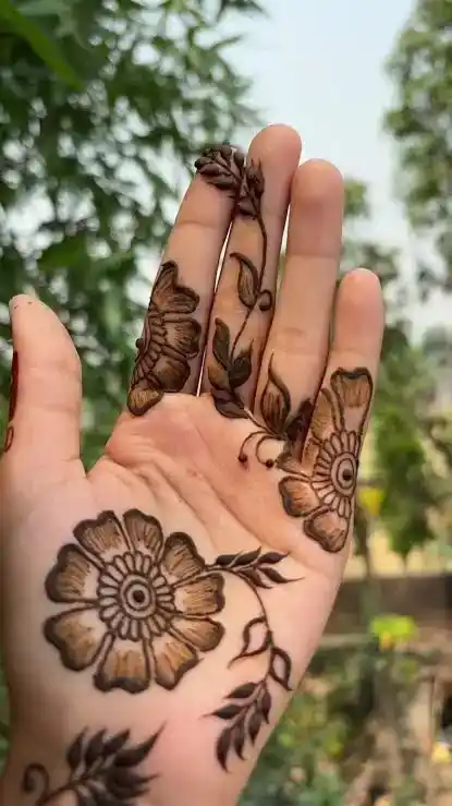 a bold Arabic mehndi design close-up: thick floral strokes, visible open space