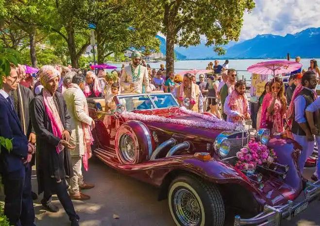 Bride arriving in a vintage car for a royal Jaipur palace wedding entry