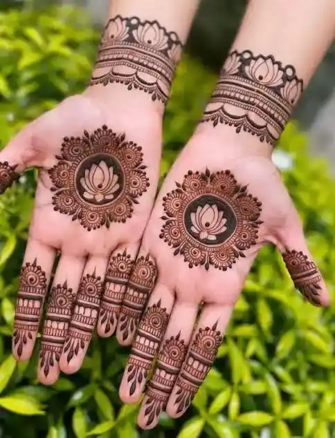 palm/front hand design with a central mandala or lotus motif and thin branching trails