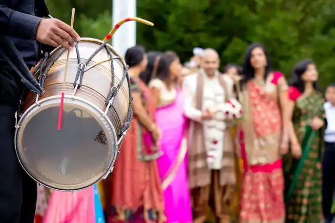 Live dhol tasha team leading a bridal entry at an outdoor sangeet